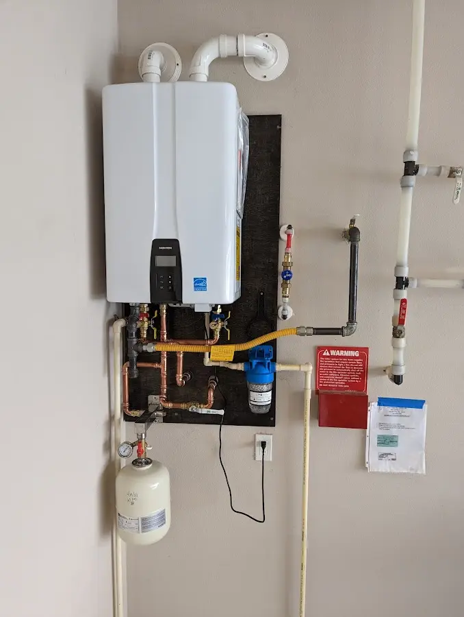 Professional plumber installing copper piping in a Douglas home